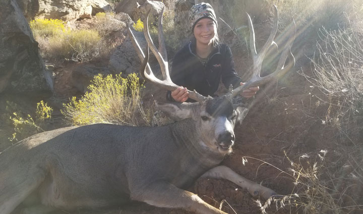 Hunter poses with a large mule deer buck