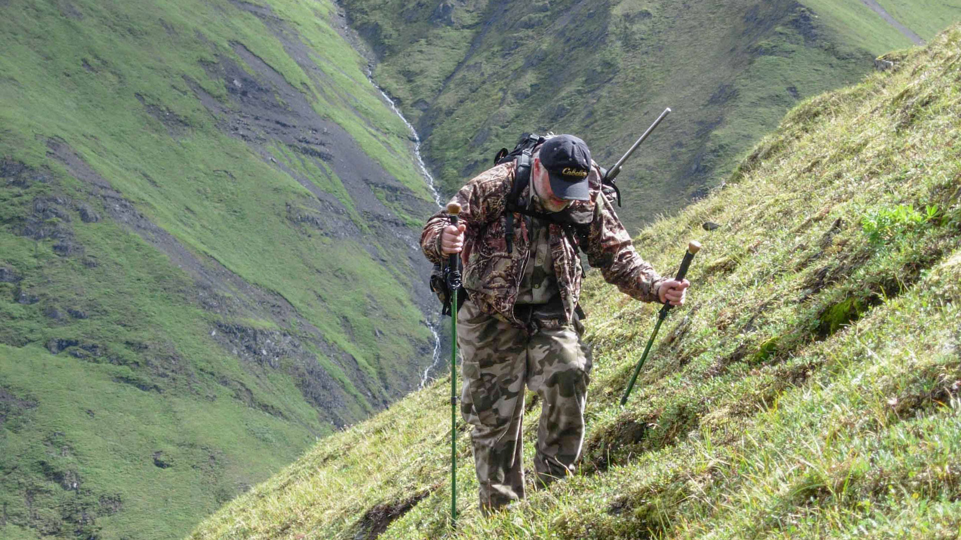 Hunter hiking a hillside