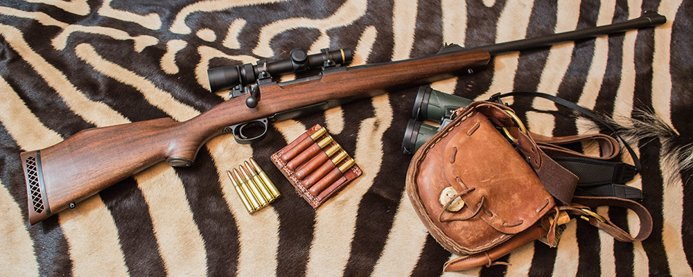 .318 Westley Richards ammunition on zebra rug with rifle.