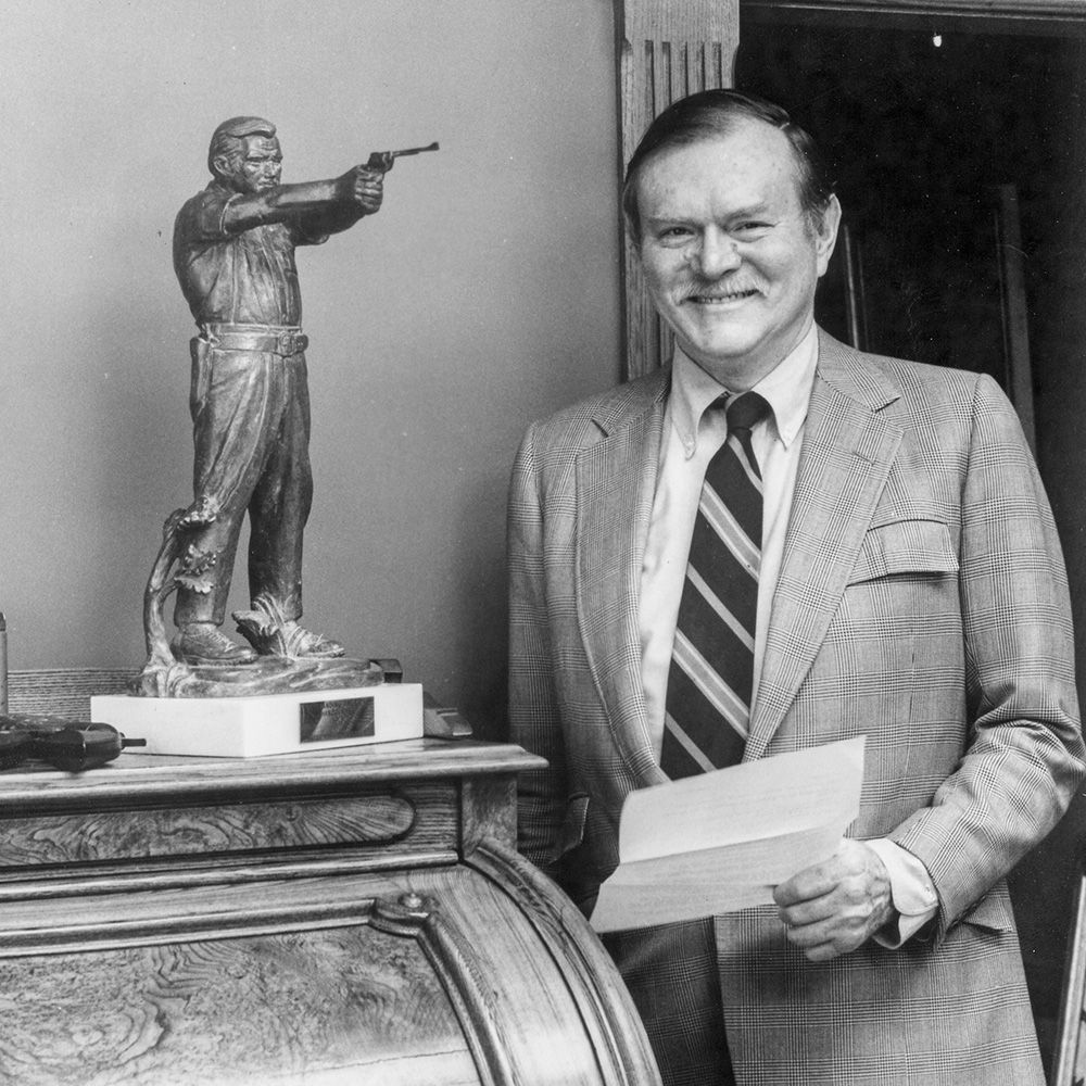 Bill Ruger standing next to award.