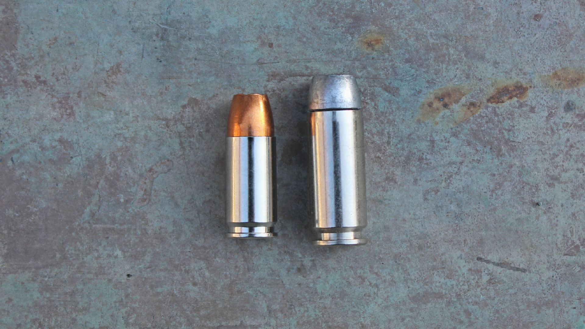 9mm cartridge next to 10mm cartridge