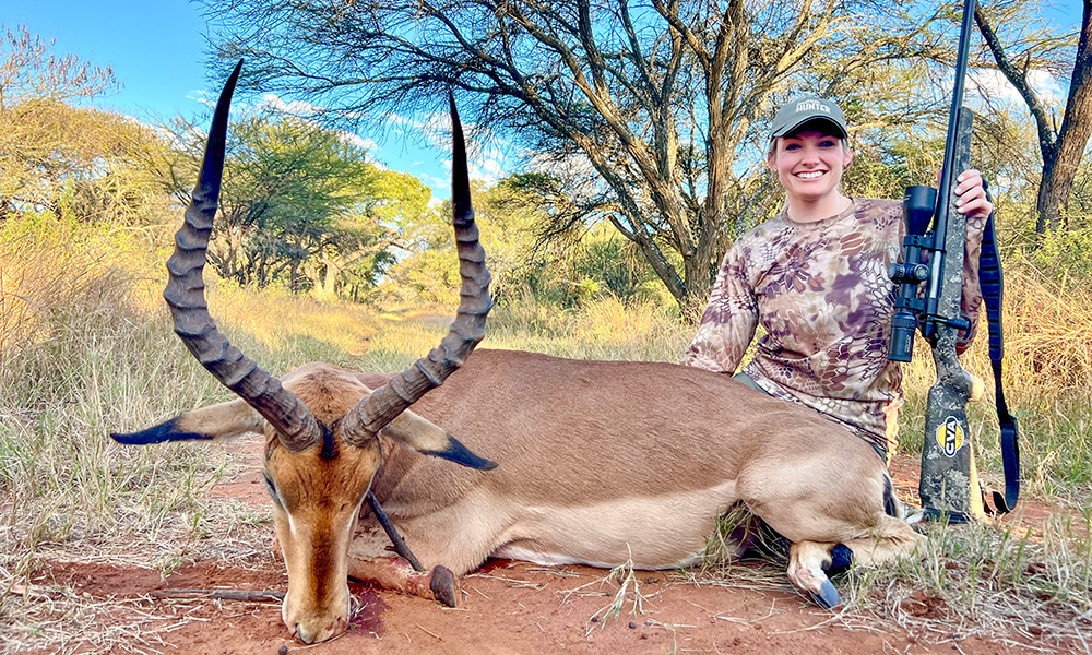 Female hunter posing with impala in South Africa.