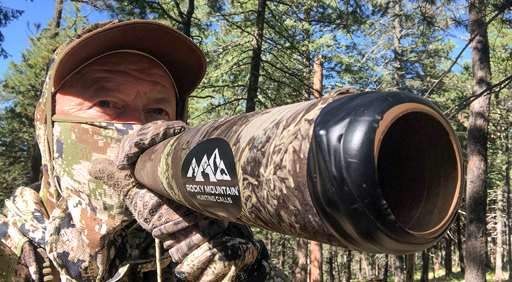 Male hunter using elk bugle call.