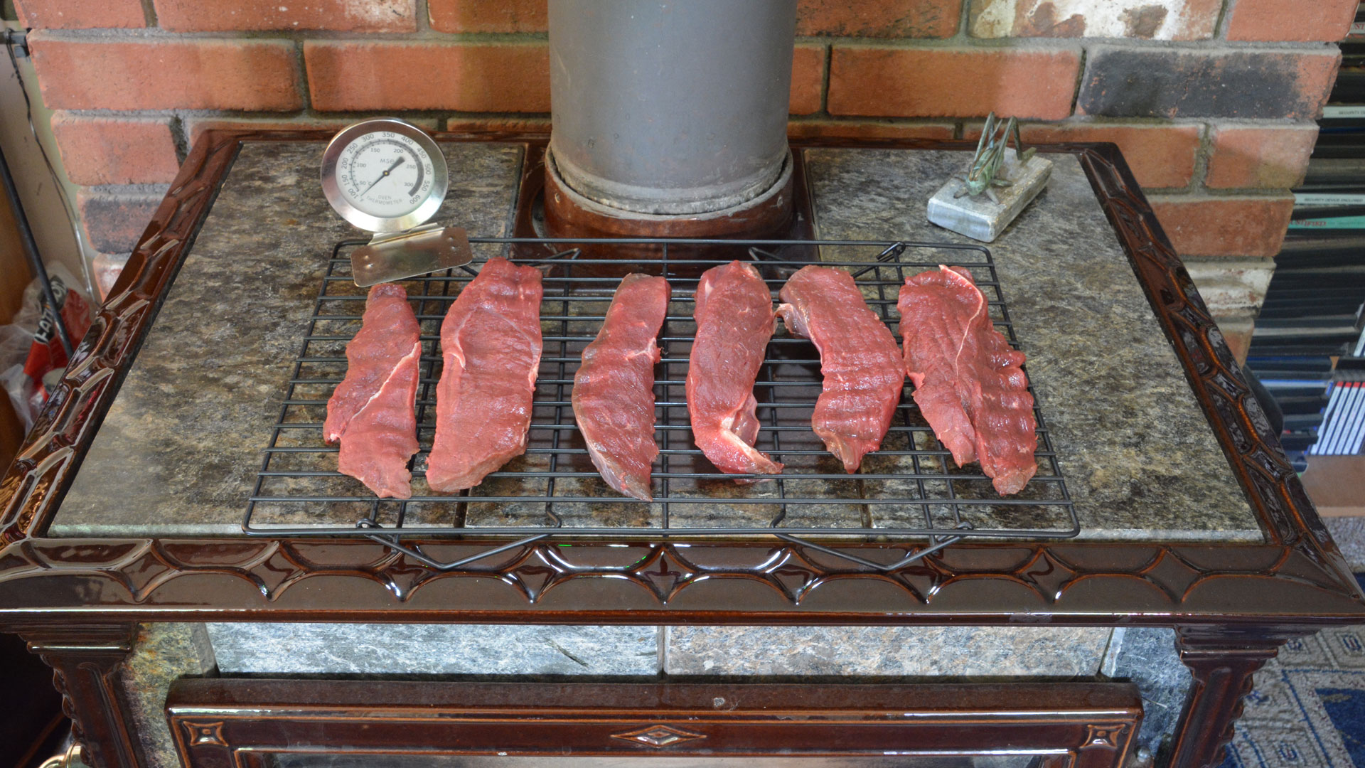Jerky on woodstove with thermometer