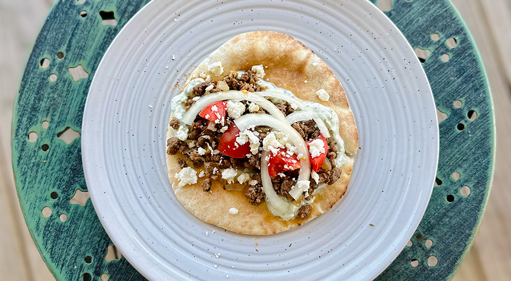 Wild pork gyro on white plate.