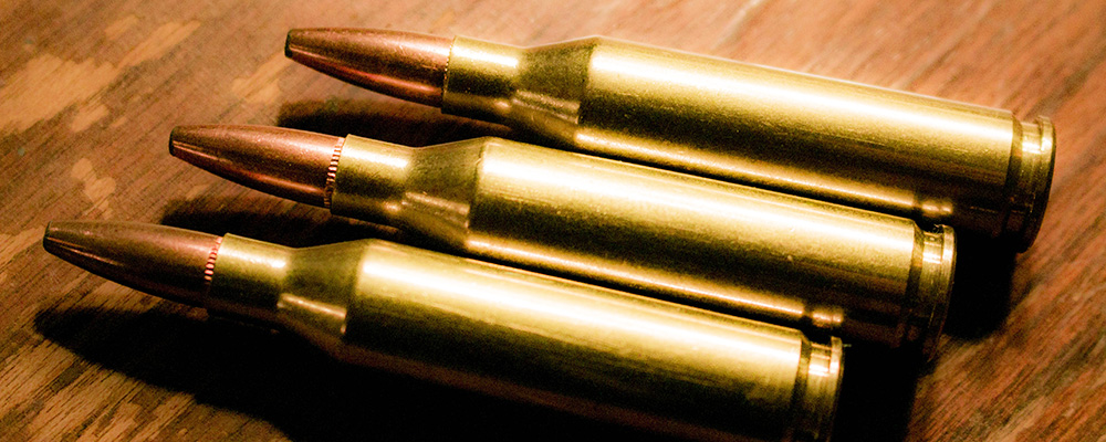 Three .243 Winchester ammunition cartridges.