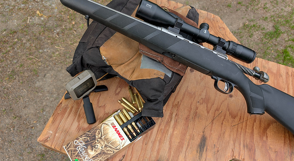 Barnes Harvest 270 Winchester ammunition with bolt action rifle on shooting bench.