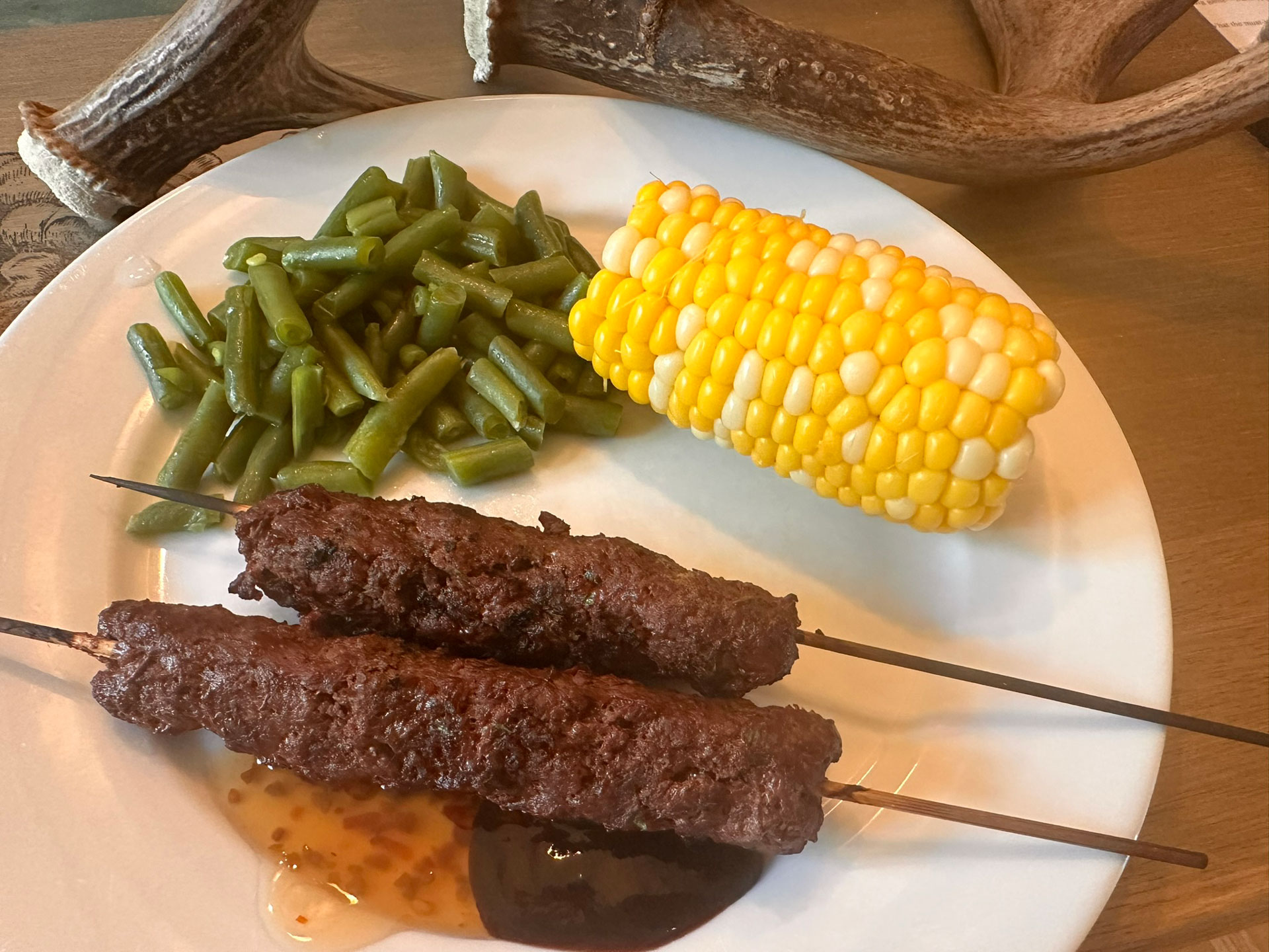 Plated meal of venison kebabs