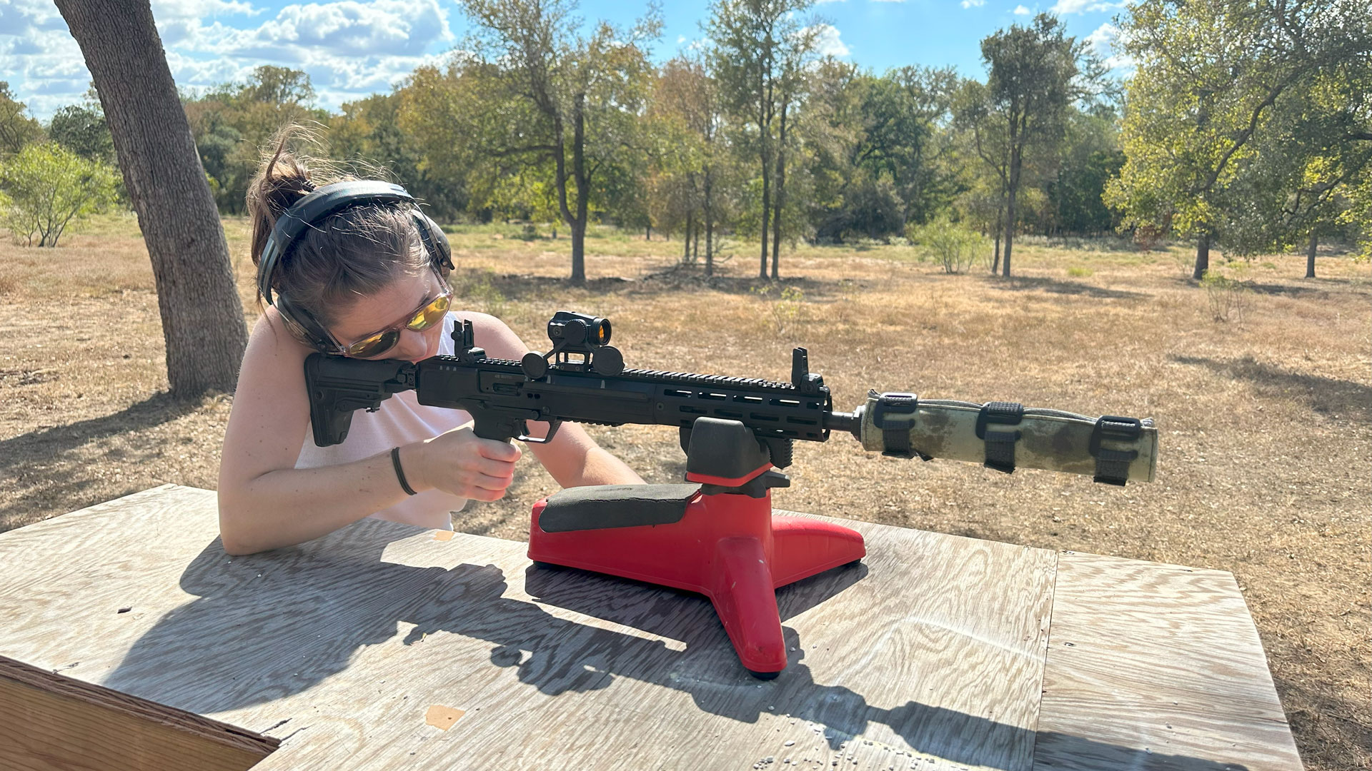 Girl shooting AR out of rest