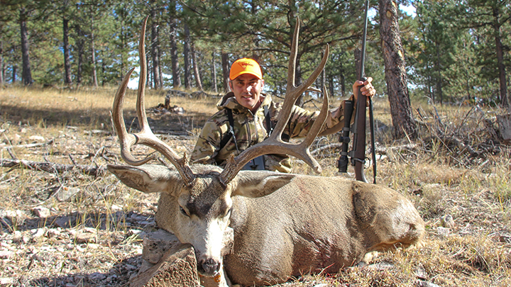 Hunter with big mule deer buck