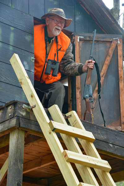 Hunter peeks out of blind