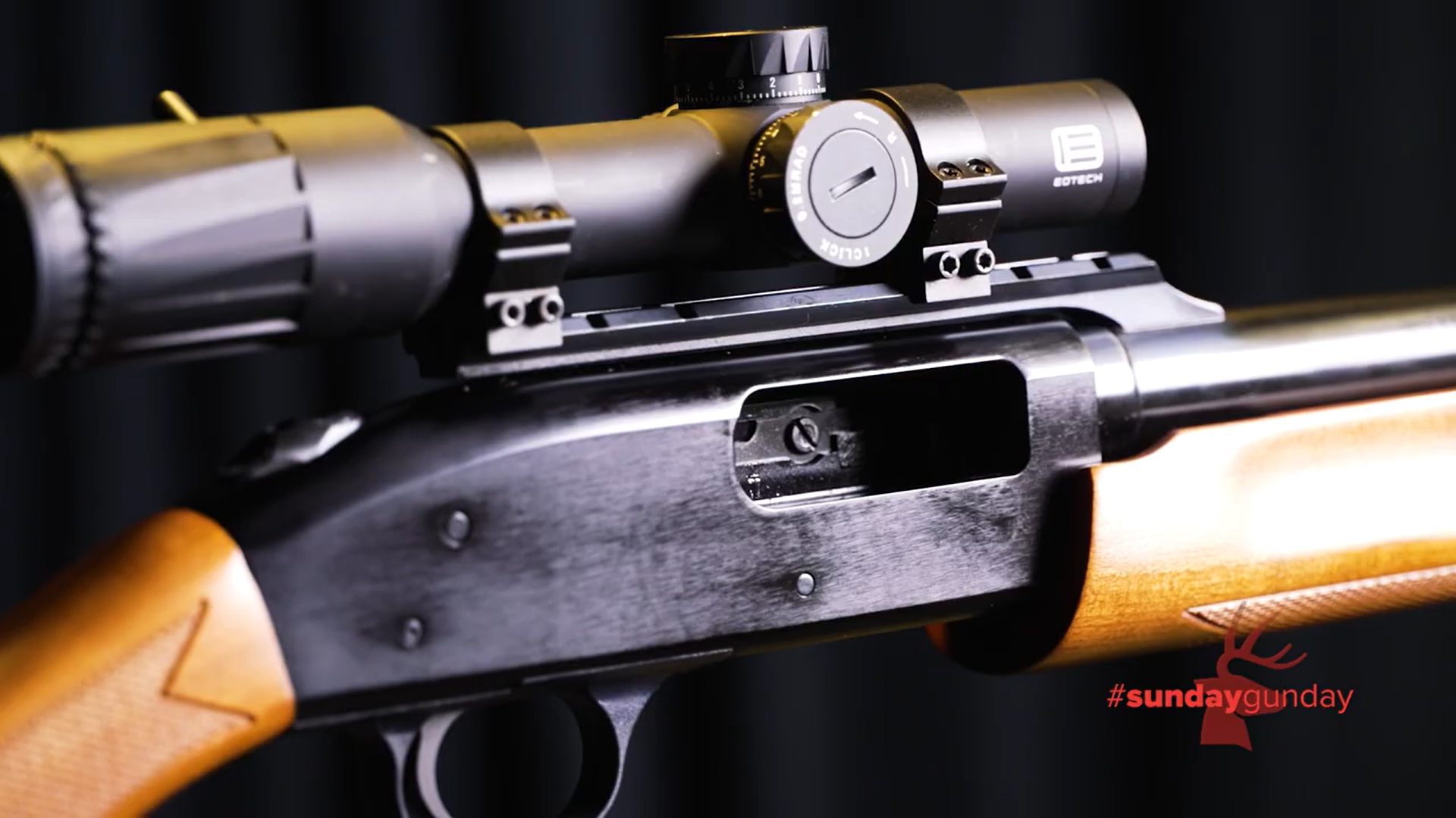 Mossberg Model 500 Combo shown closeup of action receiver aluminum wood stock and black eotech riflescope attached to top of rail