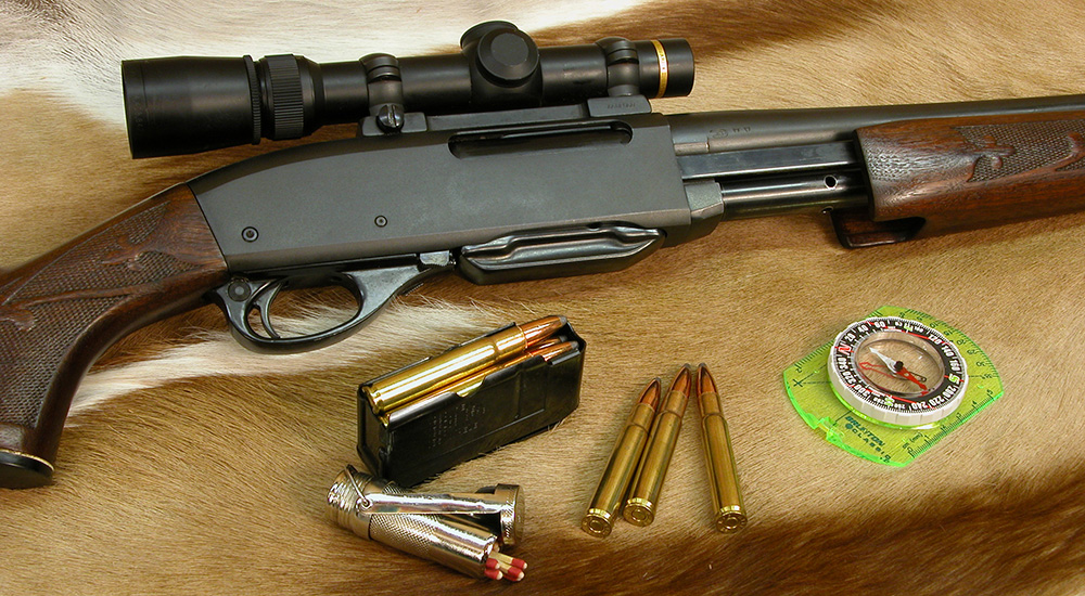 Townsend Whelen's Remington 7600 chambered in .35 Whelen with three rifle cartridges on deer hide.