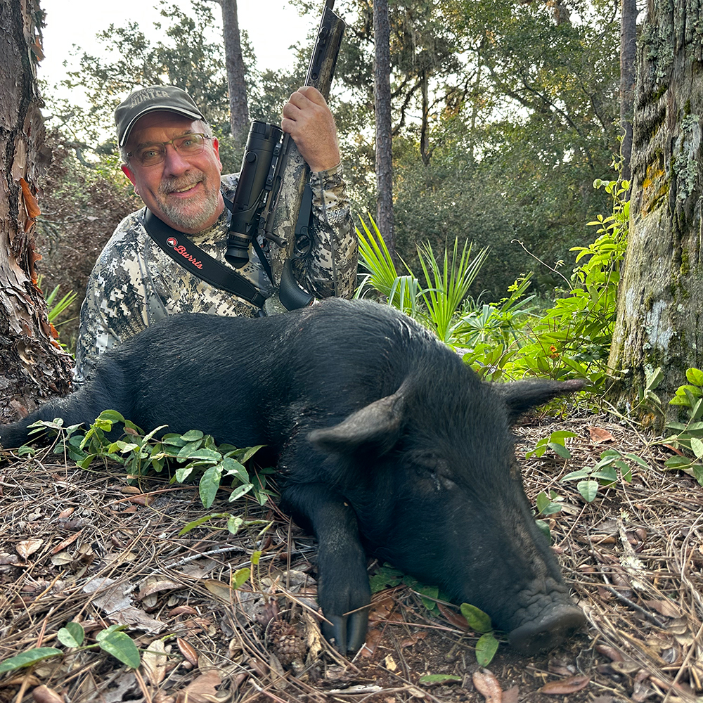 Male hunter with feral hog in Florida.