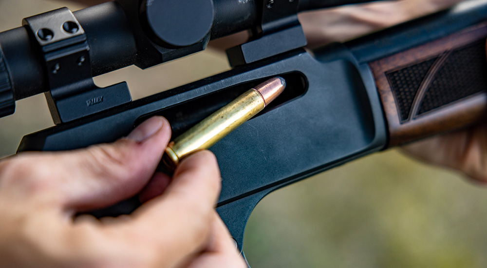 Remington 360 Buckhammer ammunition being loaded into lever action rifle.